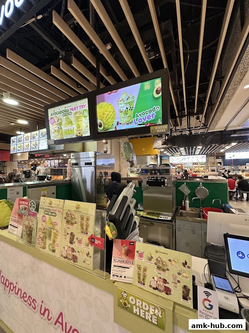 Avocadoria shop counter with digital menu boards and product displays.