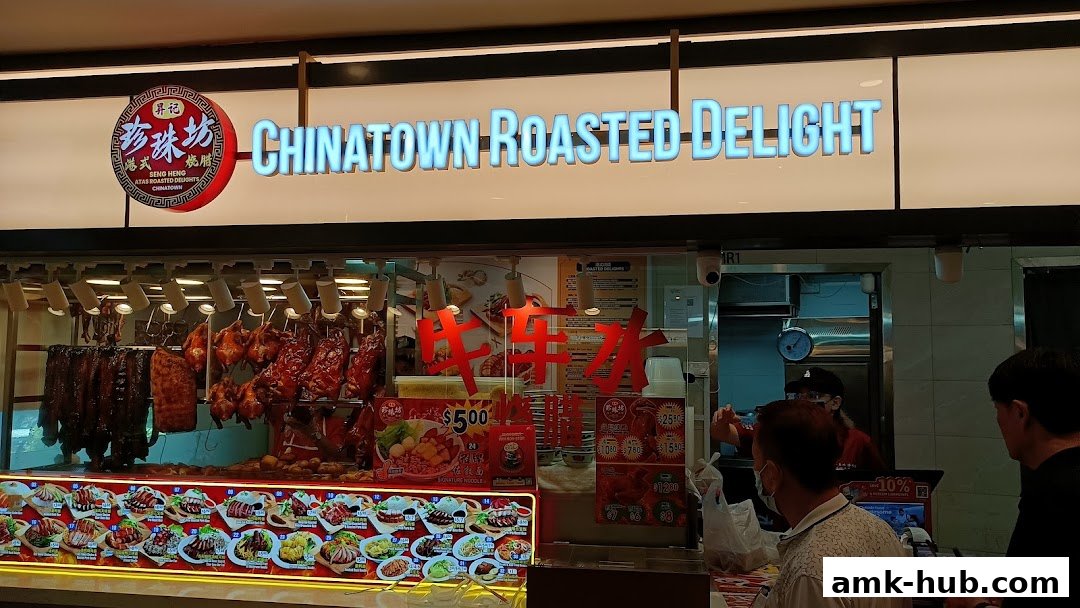 A brightly lit shop front displaying various roasted meats and a colorful menu.