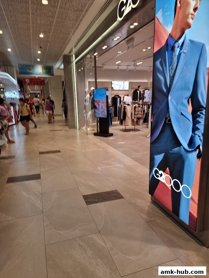 The G2000 store entrance with mannequins and clothing displays, and a large advertisement.