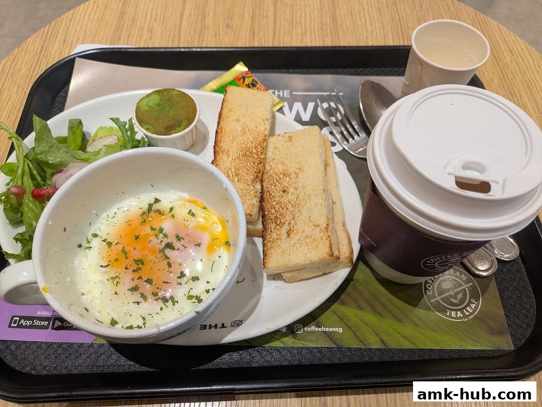 A breakfast set with a fried egg, toast, salad, and a coffee from The Coffee Bean and Tea Leaf.