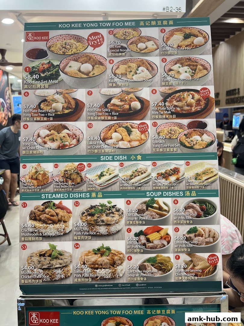 A menu board for Koo Kee Yong Tow Foo Mee, showcasing various noodle and rice dishes with prices.