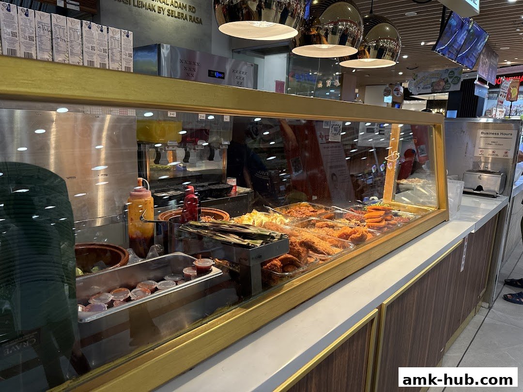 A display counter filled with various nasi lemak dishes and condiments at Crave.