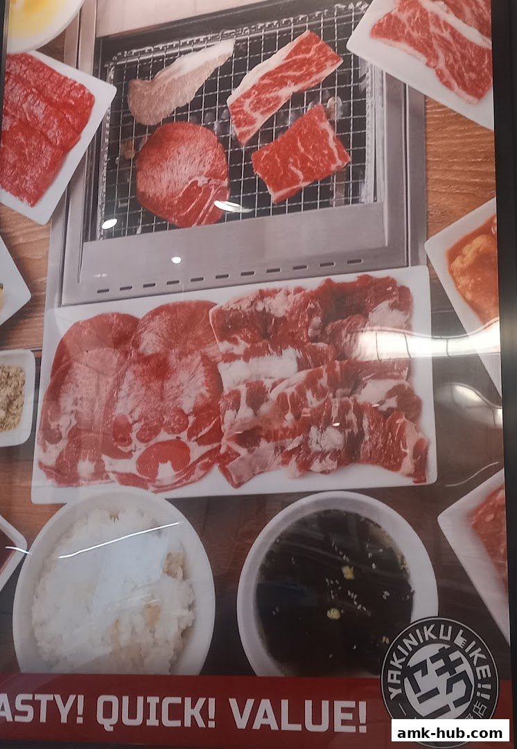 A display of raw meat cuts, rice, and dipping sauce for yakiniku.