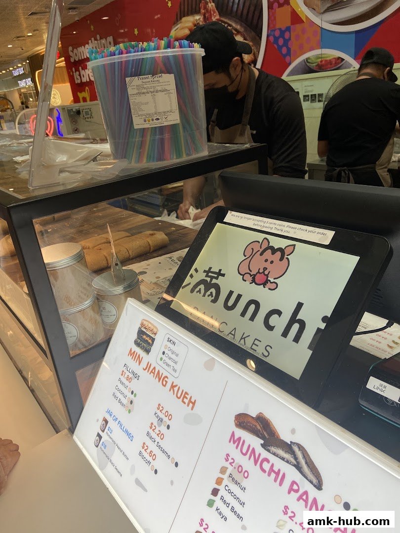 A menu board for Munchi Pancakes with various pancake fillings and options.