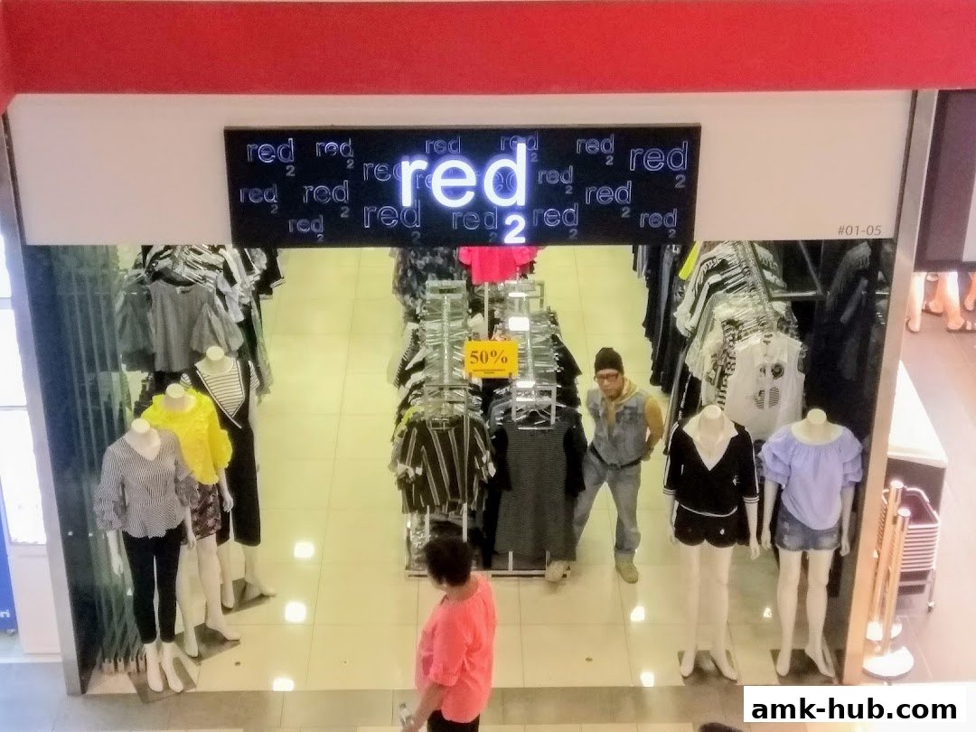 A view from above into a clothing store with mannequins and racks of clothes.