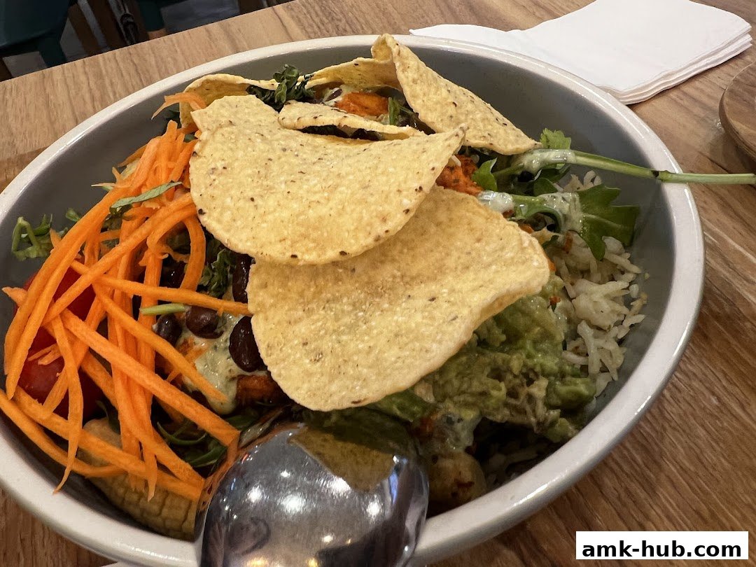 A close-up of a healthy and colorful salad bowl with tortilla chips and fresh ingredients.