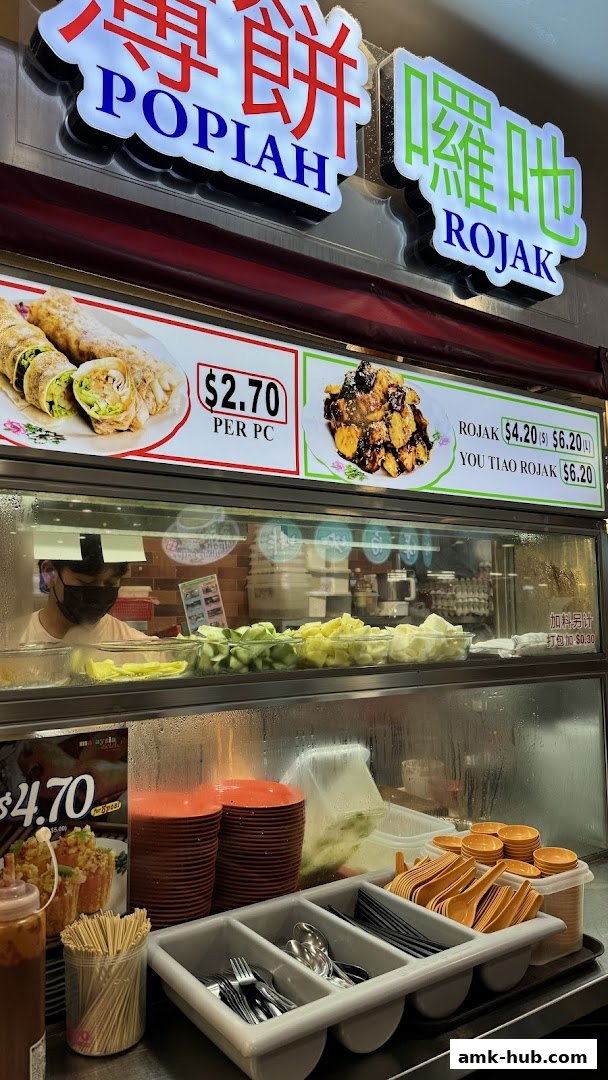 A food stall displaying Popiah and Rojak with prices and ingredients.