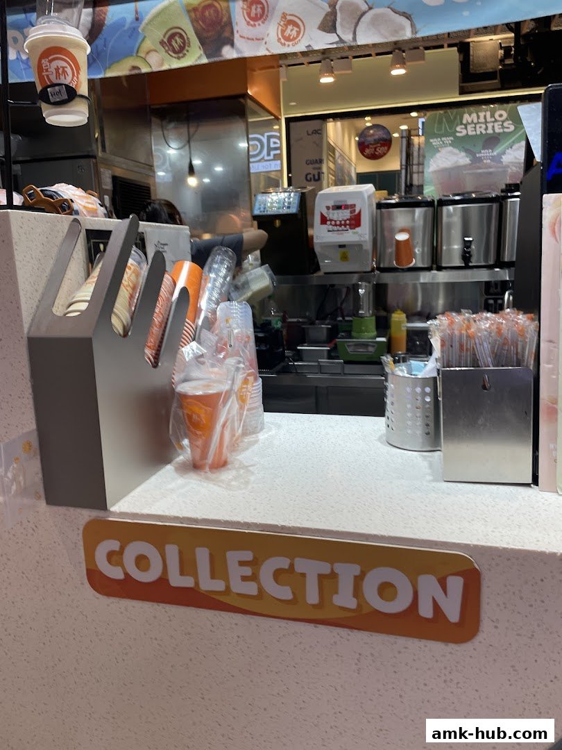 A counter at 'Each A Cup' with drinks, cups, and a 'COLLECTION' sign.
