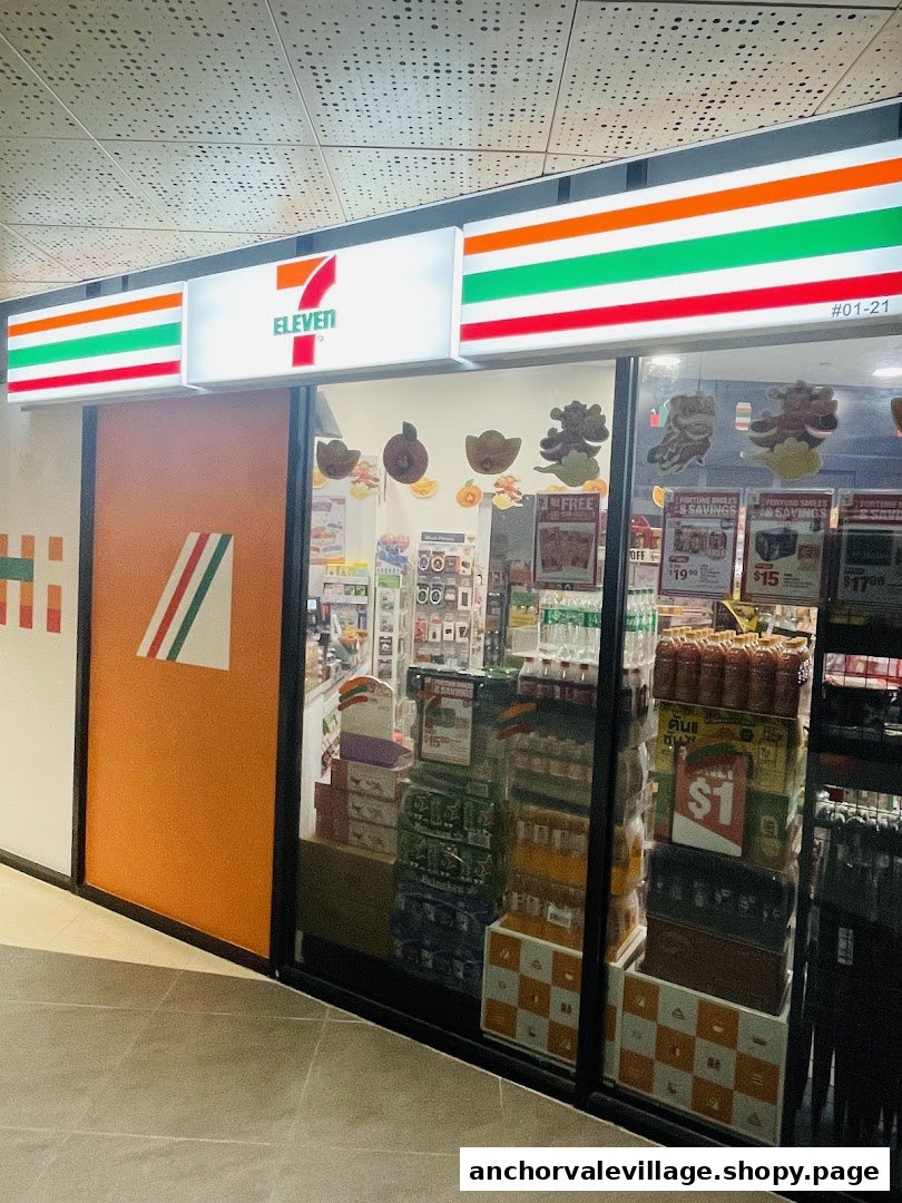 The brightly lit exterior of a 7-Eleven convenience store, showcasing its entrance and window displays.