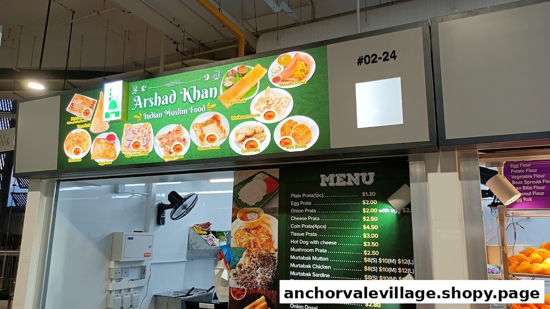 A brightly lit signboard and menu display for Arshad Khan Indian Muslim Food, showcasing various prata and dosai dishes.