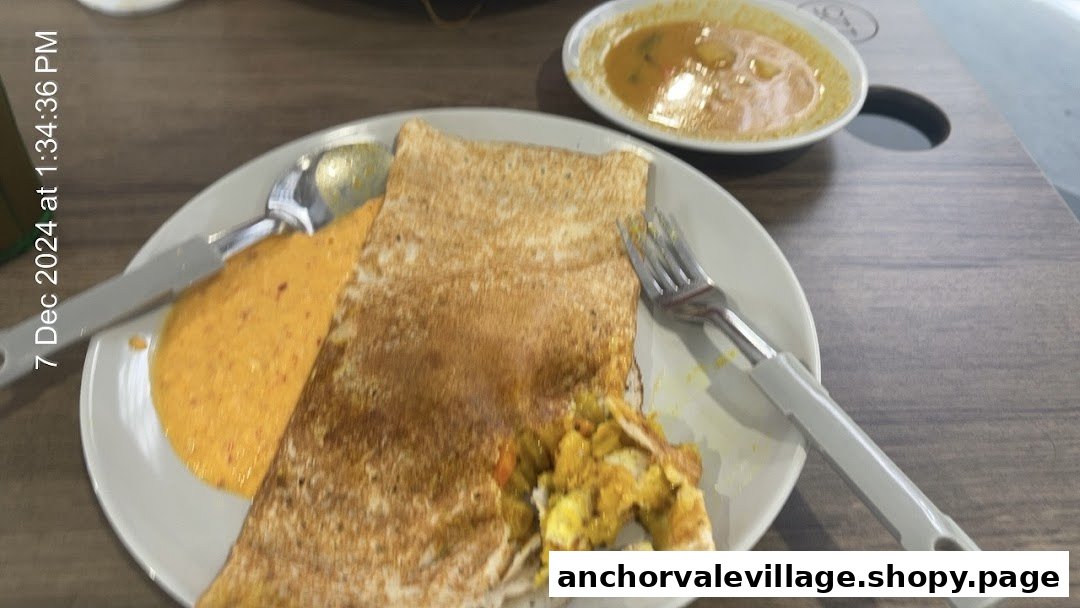 A delicious Indian dosa filled with potato masala, served with red chutney and sambar.