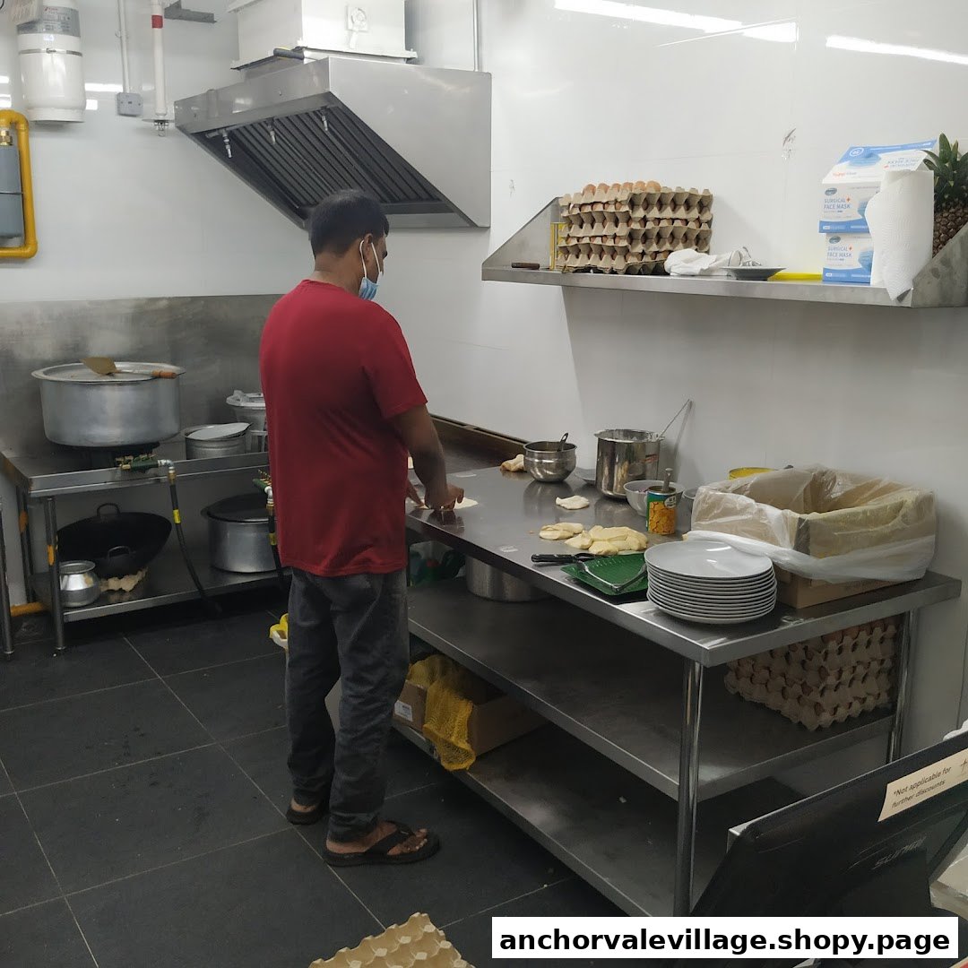 A chef in a clean kitchen preparing dough for Indian Muslim food.