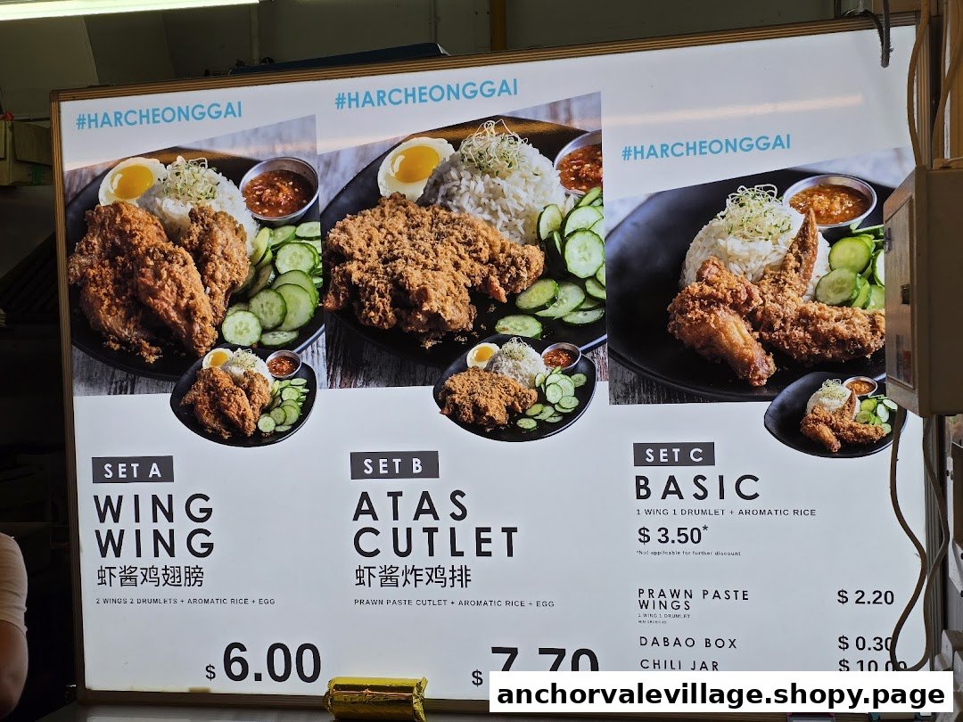 A brightly lit menu board displaying various prawn paste chicken sets and ala carte items.