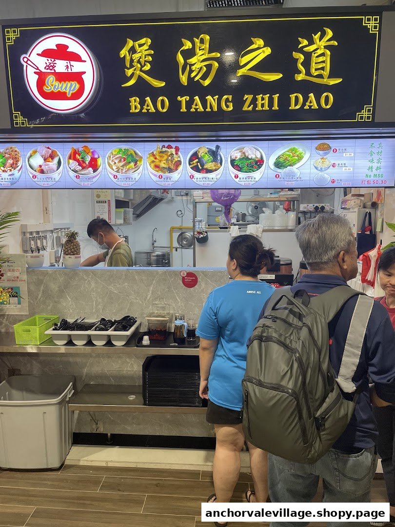 Customers queue at Bao Tang Zhi Dao, a soup stall featuring a large menu board and open kitchen.