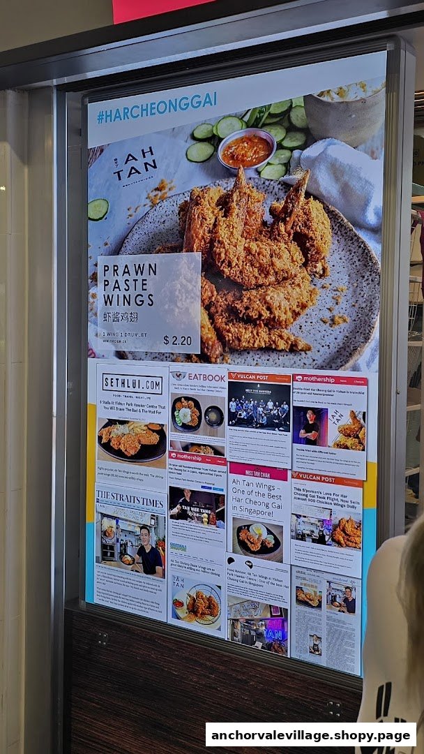 Promotional menu board for Ah Tan Wings, featuring prawn paste wings and media accolades.