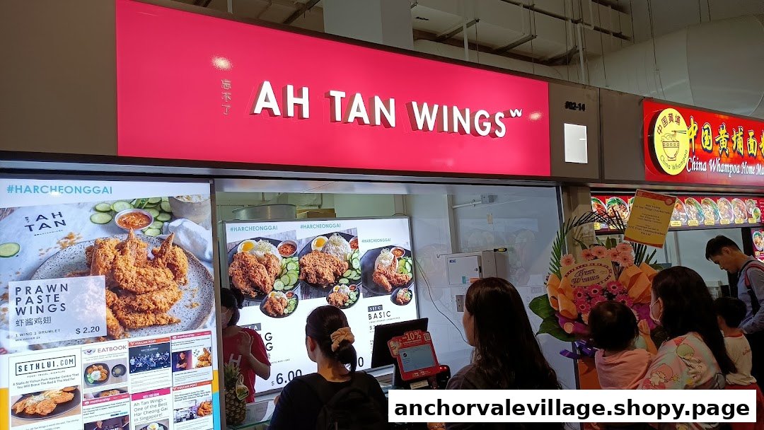 The vibrant storefront of Ah Tan Wings, showcasing its signature prawn paste wings and customer service area.