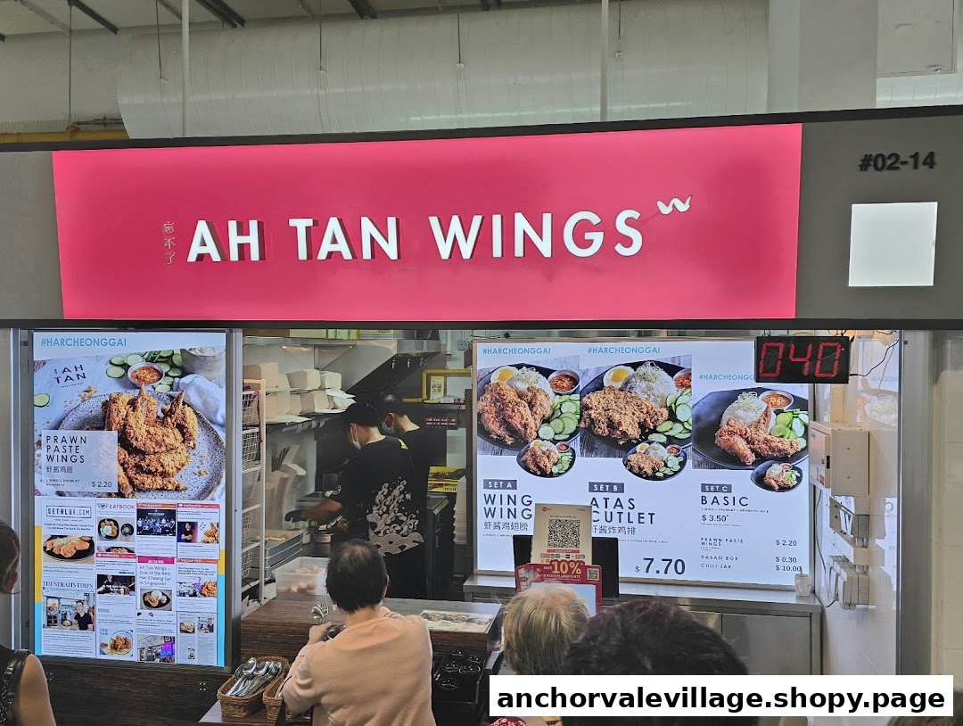 A bustling hawker stall, Ah Tan Wings, showcasing its signature prawn paste wings and menu sets.