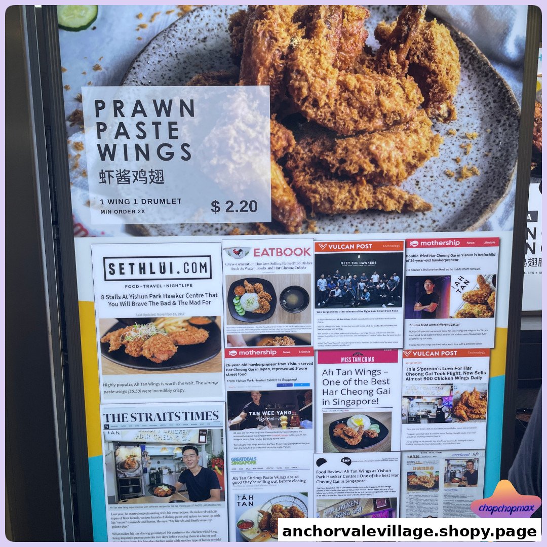A promotional display for Ah Tan Wings, featuring Prawn Paste Wings and various media reviews.