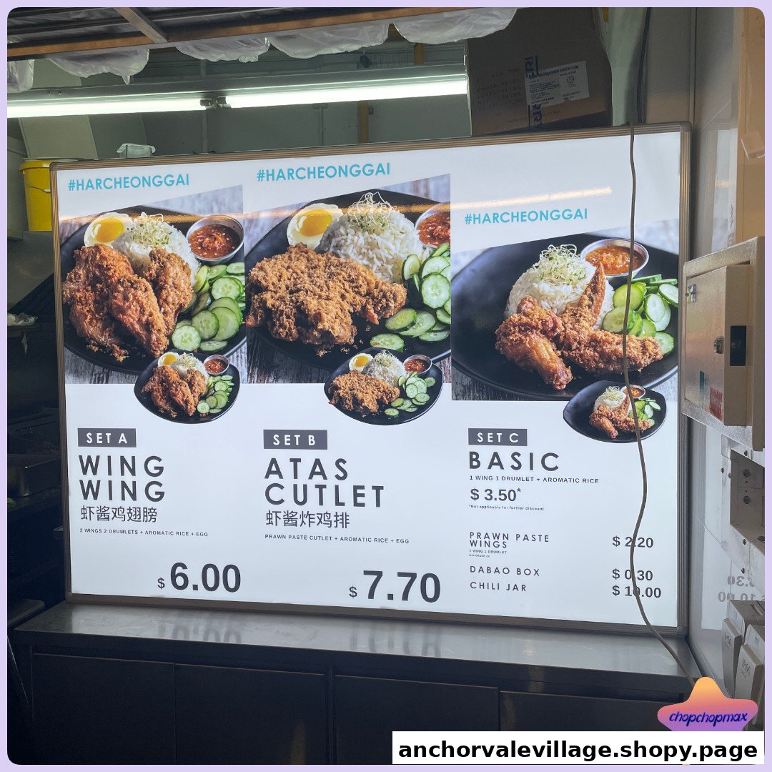 A brightly lit menu board displaying various fried chicken and cutlet sets with rice and egg.