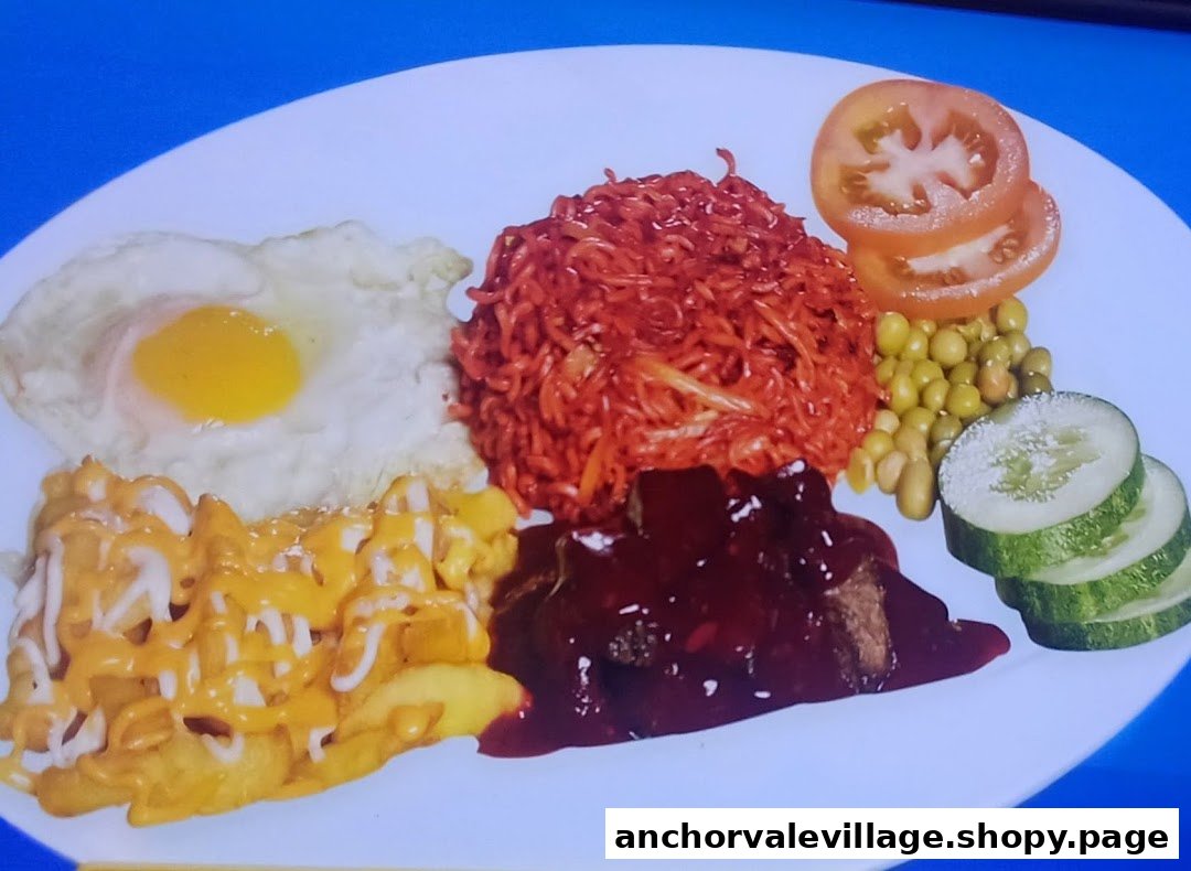 A vibrant combo plate featuring noodles, fried egg, fries, meat, and fresh vegetables.
