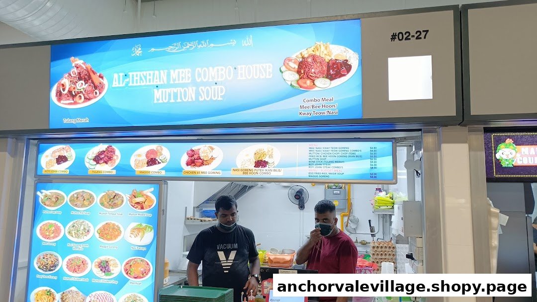 Two staff members at Al-Ihshan Combo House Mutton Soup, with menu boards displaying various dishes.