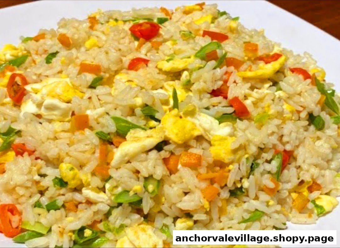A vibrant plate of fried rice with eggs, carrots, and green onions, ready to be enjoyed.