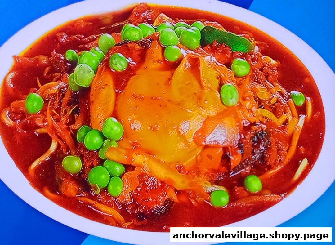 A vibrant dish featuring a large piece of meat or poultry in a rich red sauce, garnished with green peas.