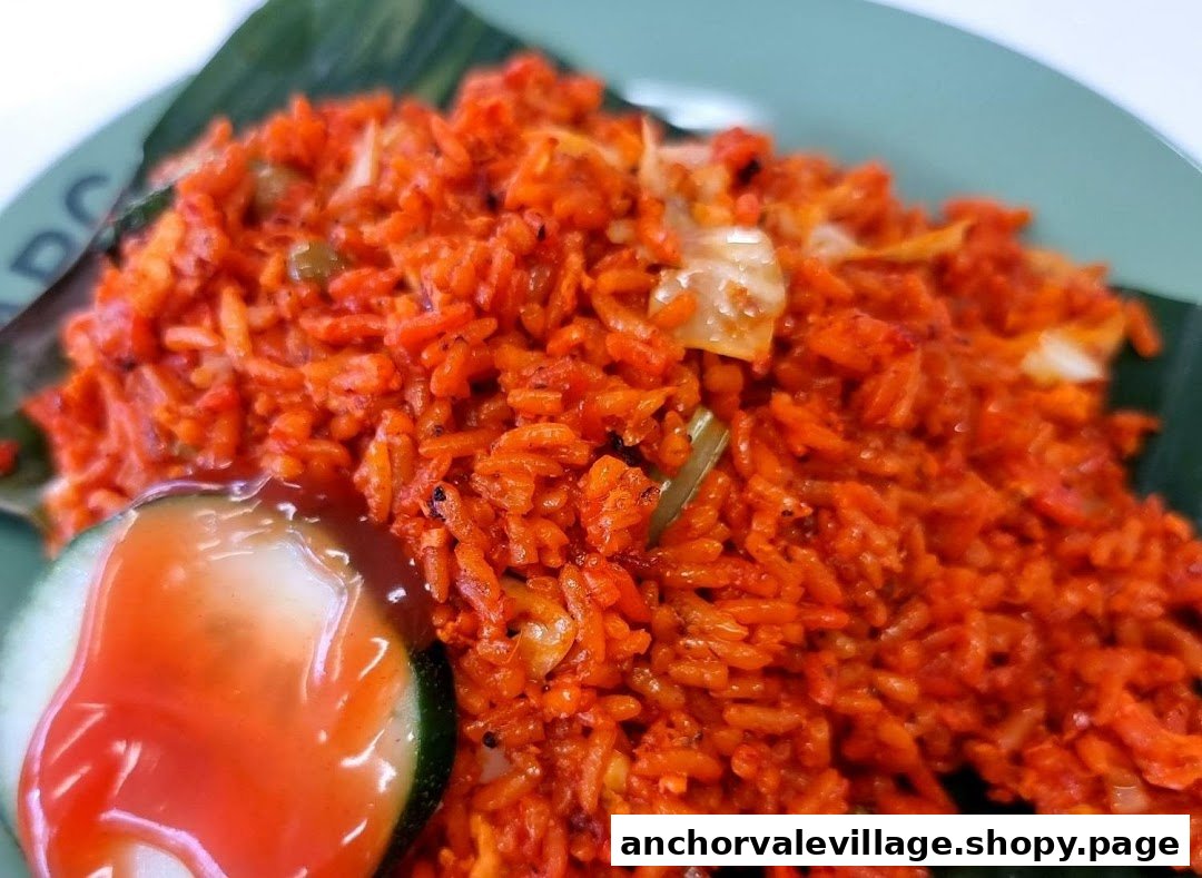 A vibrant close-up of red fried rice served with a cucumber slice and sauce.