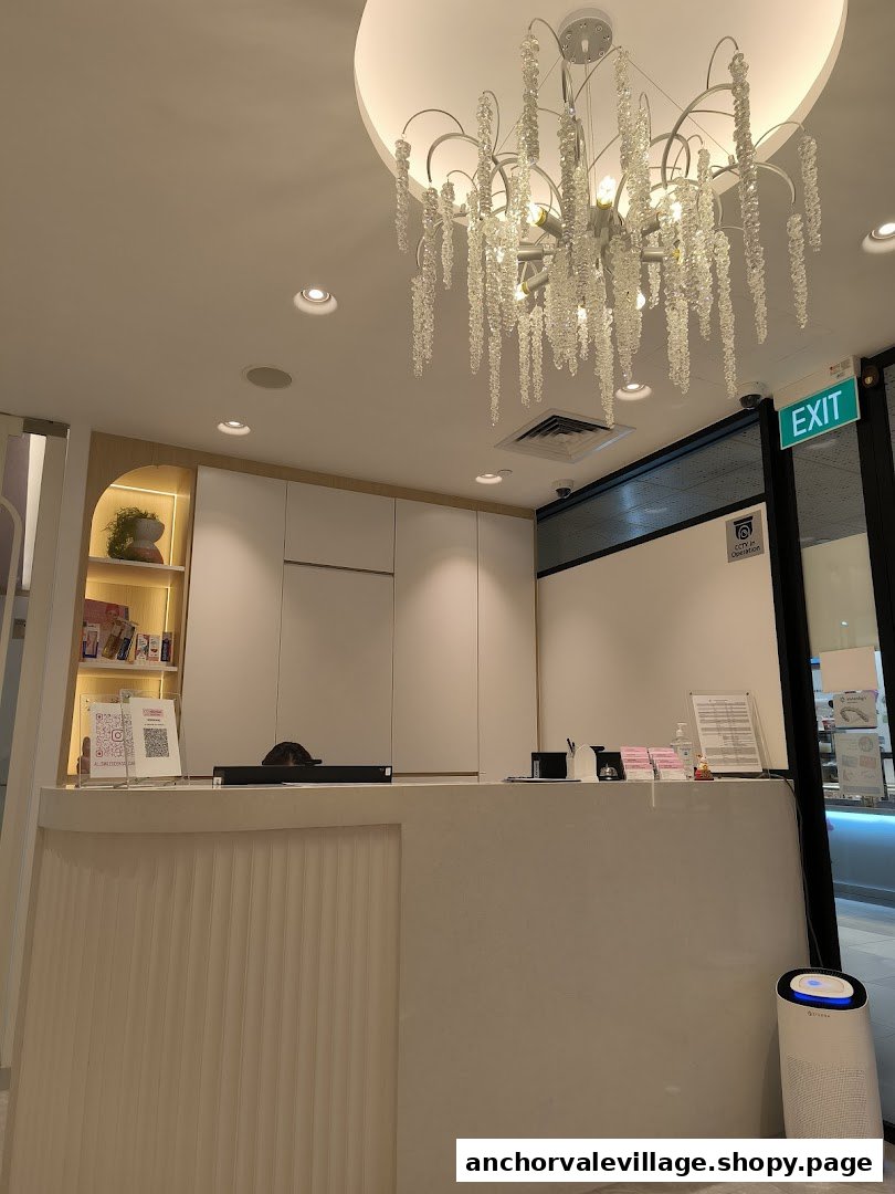 A modern and inviting reception area with a stylish chandelier at AllSmiles Dental Care Sengkang.