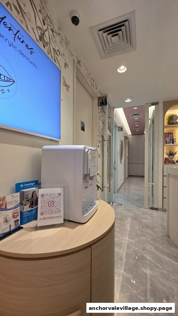 A clean, modern interior of AllSmiles Dental Care, featuring a water dispenser and information display.
