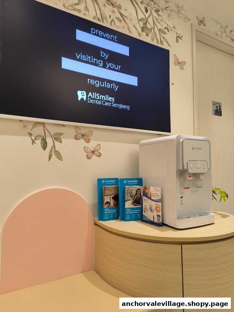 A modern and comfortable waiting area at AllSmiles Dental Care Sengkang, featuring a digital display and water dispenser.