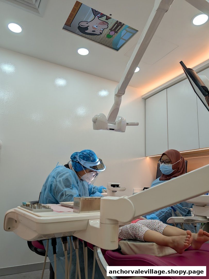 Dental professionals attend to a young patient in a modern, comfortable clinic setting.