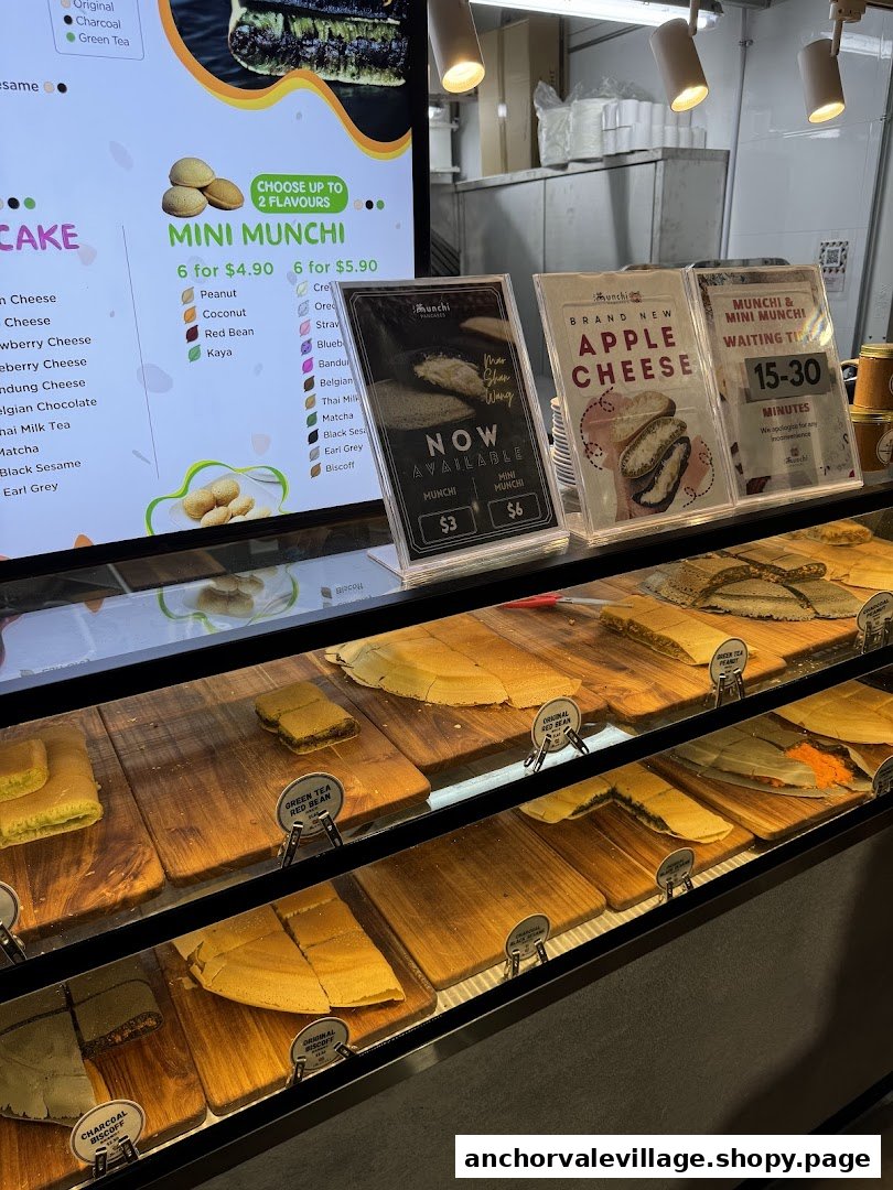 A vibrant display counter showcasing freshly made pancakes and mini munchi with digital menu and promotional signs.