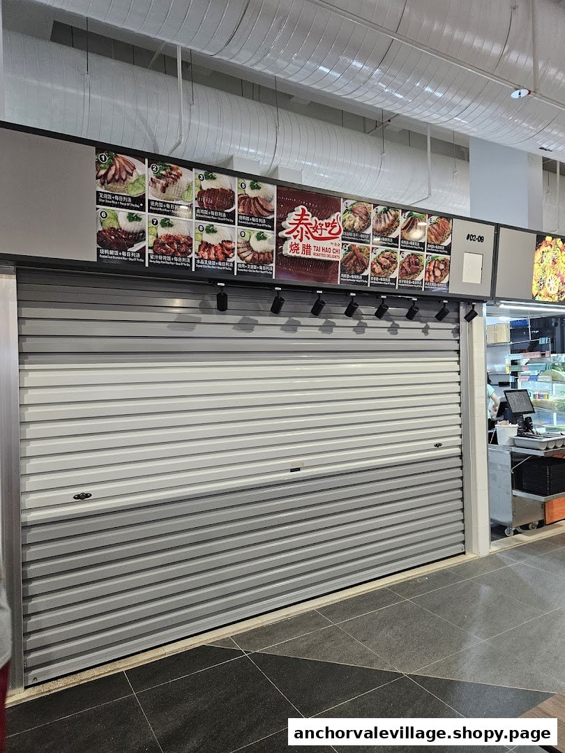 A closed hawker stall featuring a large menu display board of roasted delights and rice sets.