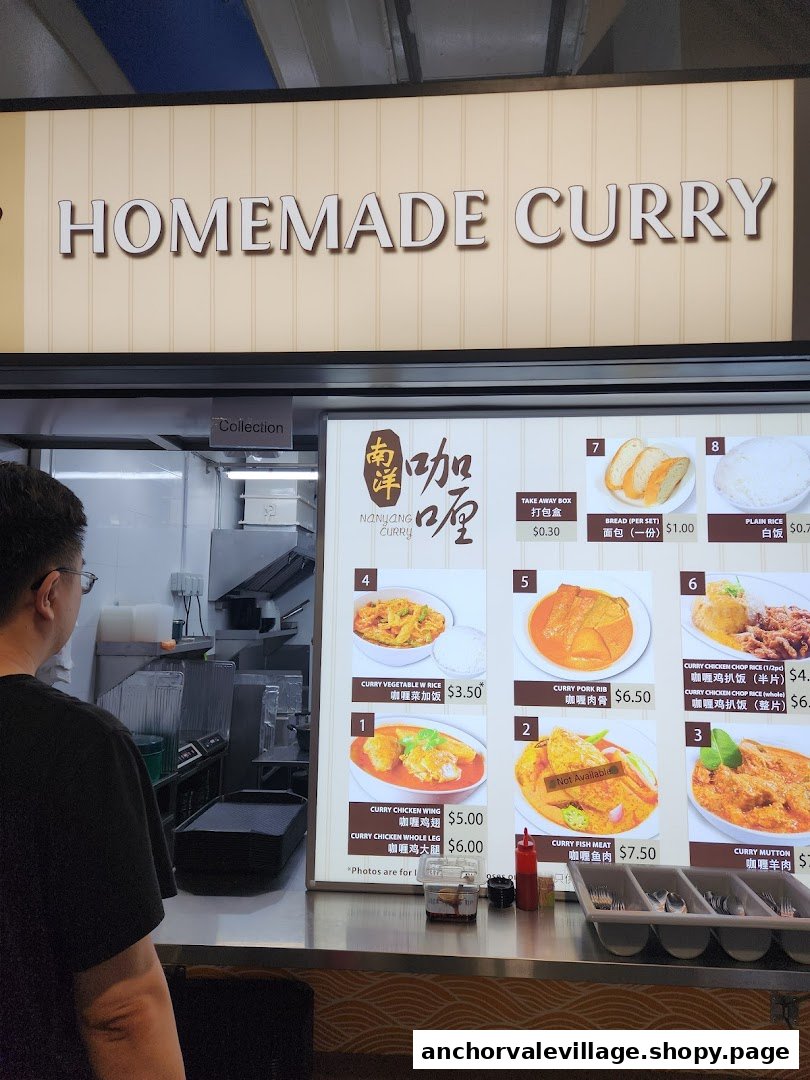 A customer views a menu board displaying various homemade curry dishes and prices at Nanyang Curry.