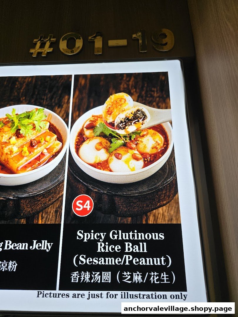 A digital menu board displaying two food items: Spicy Glutinous Rice Ball and Bean Jelly.