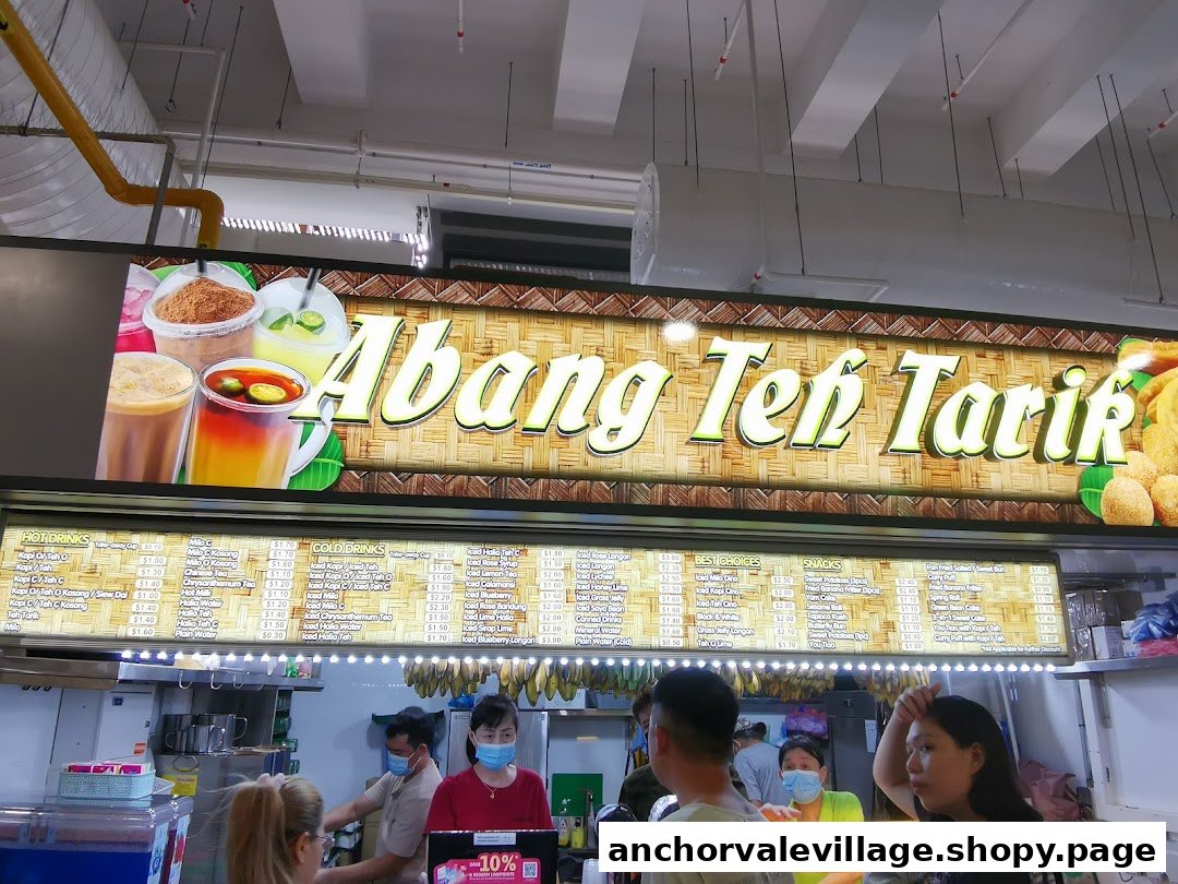 A vibrant hawker stall named Abang Teh Tarik, showcasing its extensive drink and snack menu.