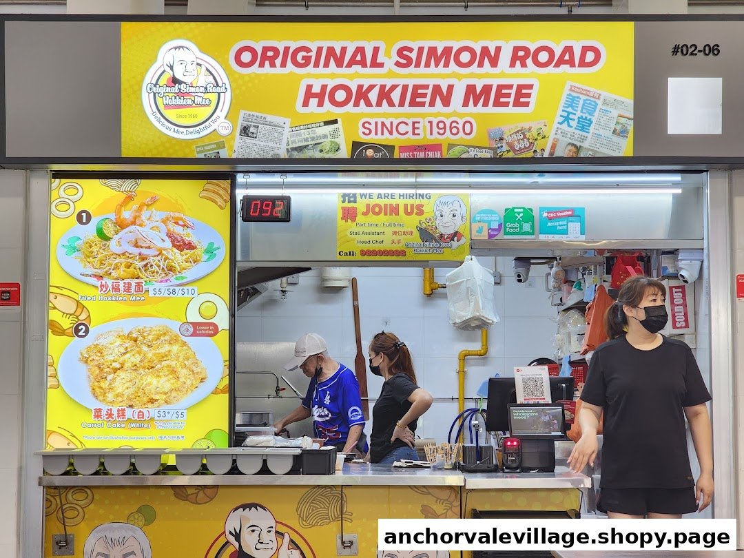 A bustling hawker stall counter showcasing popular Hokkien Mee and Carrot Cake dishes.