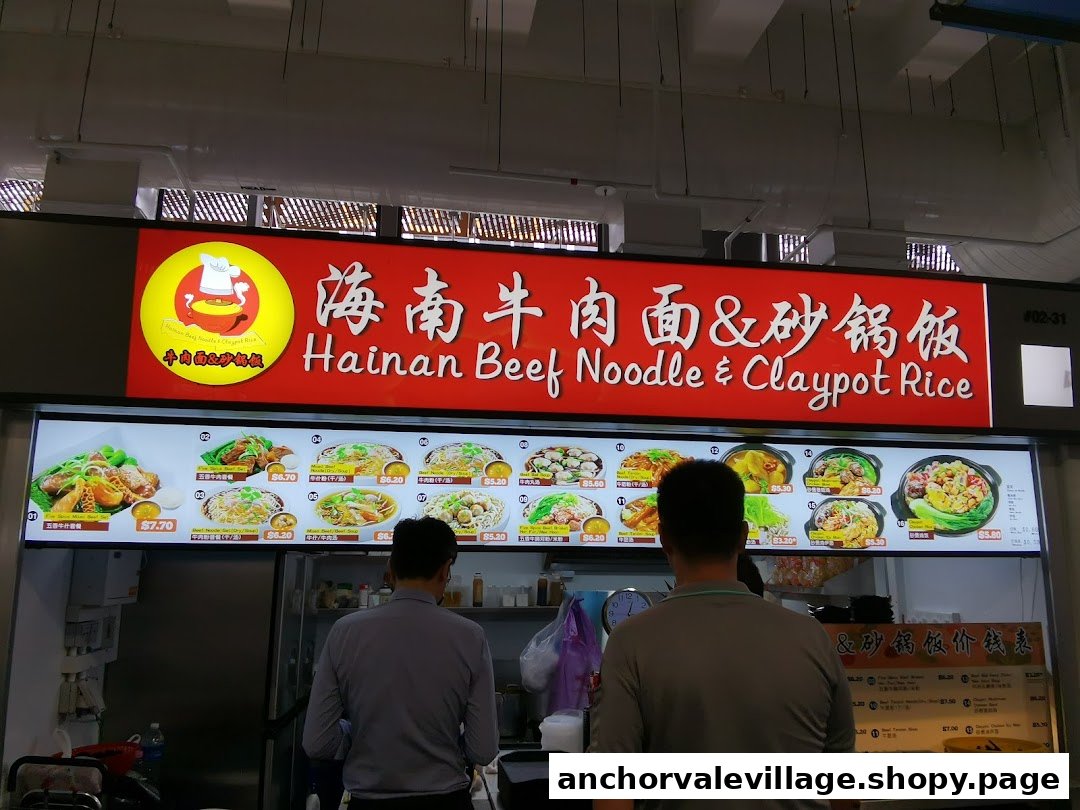 A food stall named Hainan Beef Noodle & Claypot Rice with a menu board and two customers.