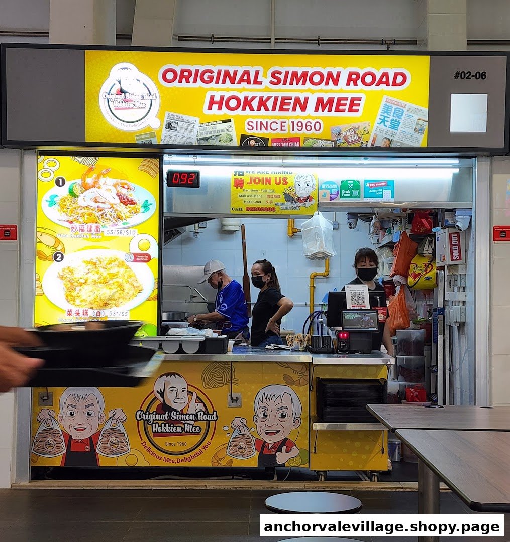 The front of Original Simon Road Hokkien Mee stall with staff preparing food and menu displays.