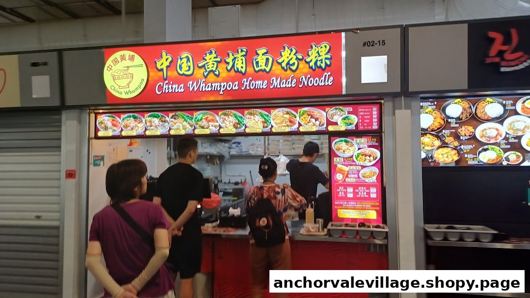 Customers queueing at China Whampoa Home Made Noodle stall, showcasing various noodle dishes and active preparation.