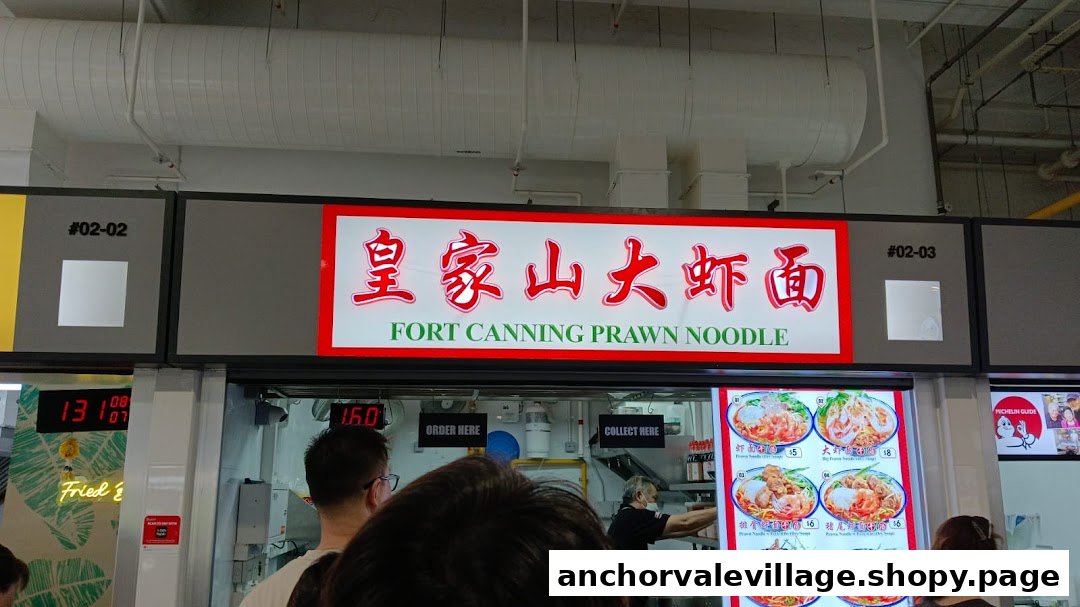 A bustling hawker stall, Fort Canning Prawn Noodle, with a vibrant menu display and customers.