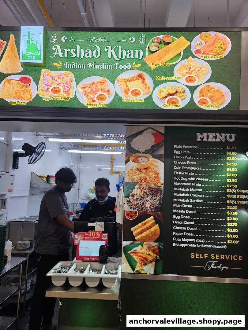 A hawker stall's menu board displaying Indian Muslim food items and prices, with staff at the counter.