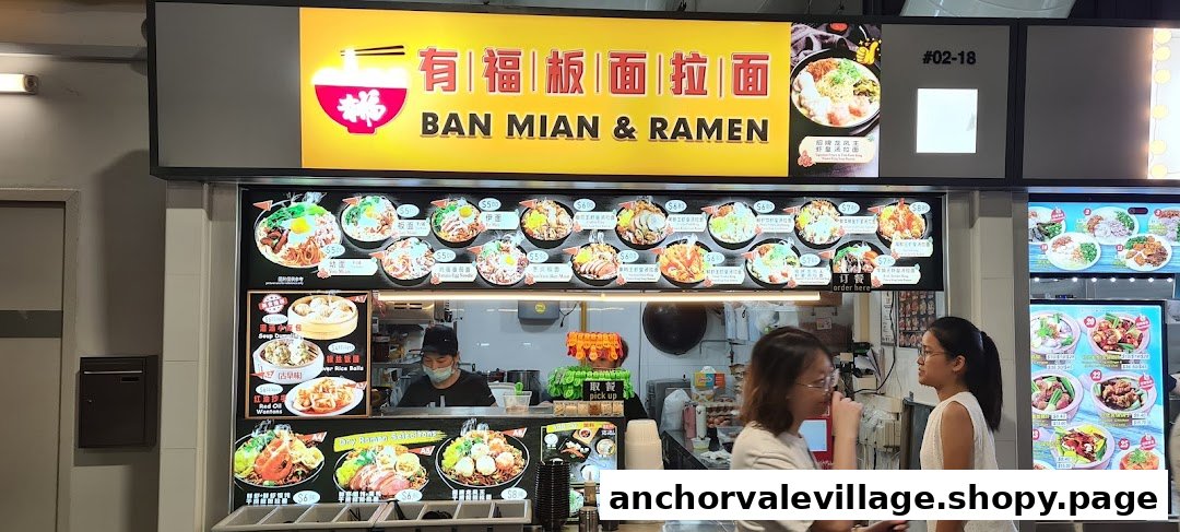 A vibrant hawker stall, 'Ban Mian & Ramen', showcasing its extensive menu of noodle dishes and sides.