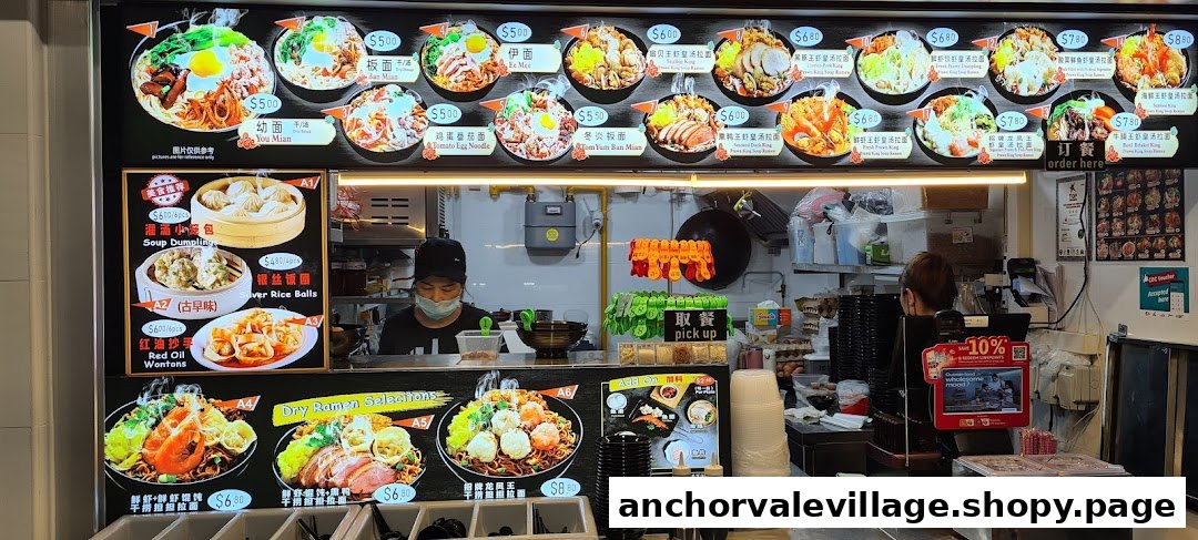 A vibrant digital menu board showcasing various noodle dishes, dumplings, and dry ramen selections at a food stall.
