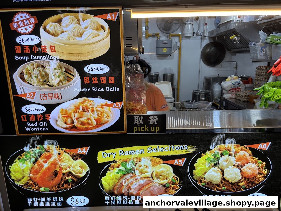 A vibrant menu board showcasing various dim sum and dry ramen dishes with prices, next to a kitchen counter.