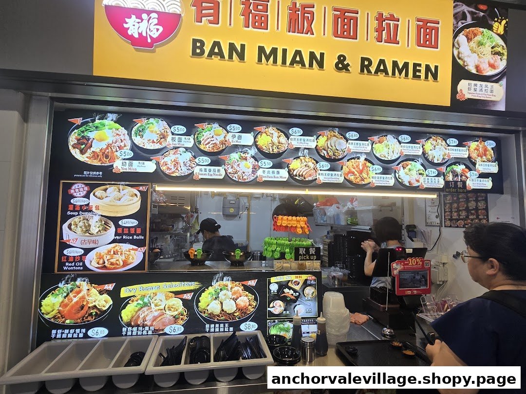 A vibrant menu board displaying various Ban Mian and Ramen dishes with prices at a food stall.
