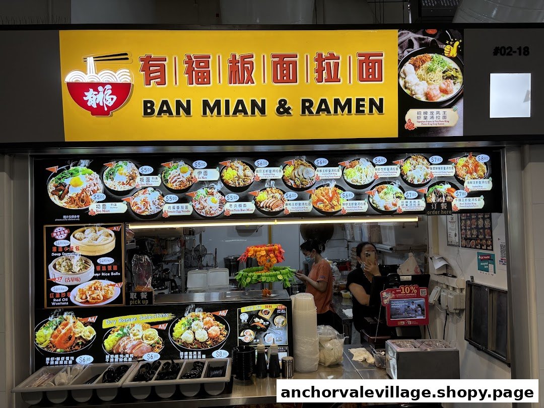 A vibrant food stall front showcasing a wide variety of Ban Mian and Ramen dishes.