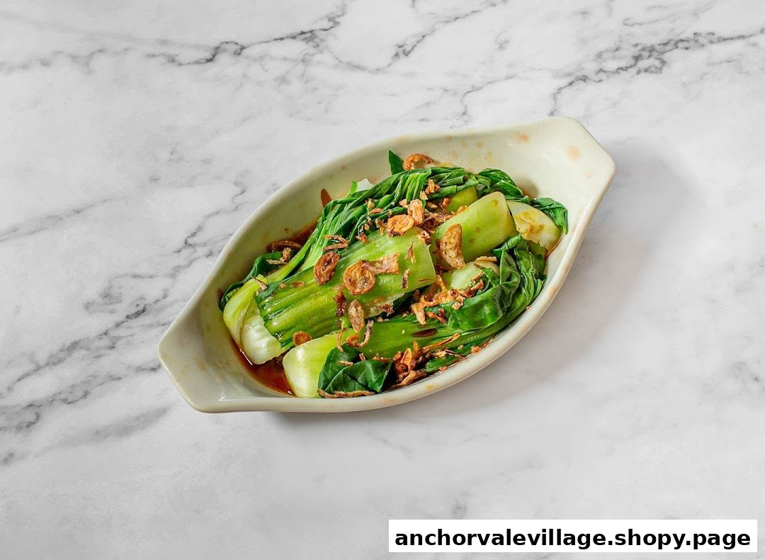 A vibrant dish of blanched green vegetables topped with crispy fried shallots in a savory sauce.