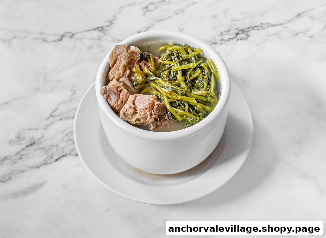 A white bowl of nourishing soup with pork ribs and green vegetables on a marble surface.